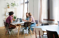 Das Bild zeigt eine Arbeitsgruppe im Hochschulambiente, die mit Tablets an einem Tisch sitzt. ©iStock / alvarez